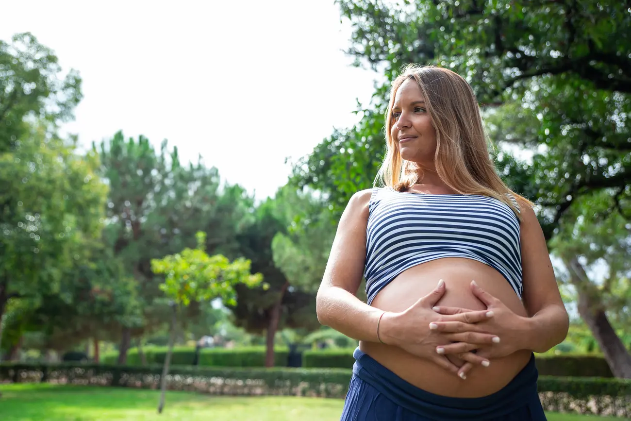 pregnant girl crossing her hands in the gut 2023 11 27 05 02 06 utc